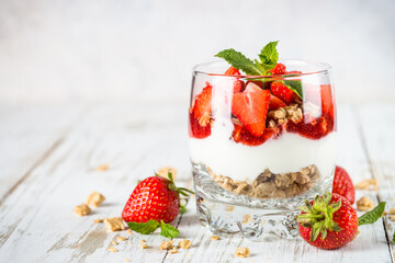 Parfait dessert. Yogurt with fresh strawberry and granola.