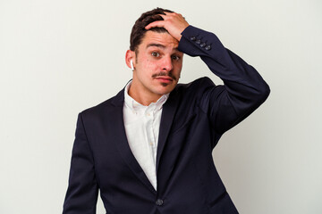 Young business caucasian man wearing wireless headphones isolated on white background being shocked, she has remembered important meeting.