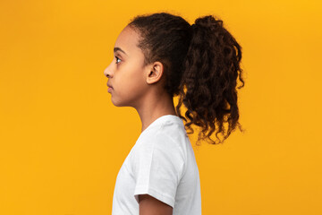 Side view profile portrait of serious African American girl - Powered by Adobe