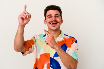 Young caucasian man isolated on white background dancing and having fun.