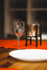 Empty table with red tablecloth served for reception of guests for dinner