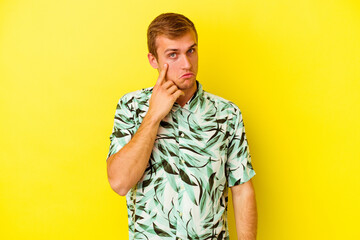 Young caucasian man isolated on yellow background