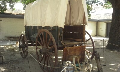 Pioneer Wagon Display From Sutter's Fort with Wooden Wheels and a Canvas Canopy