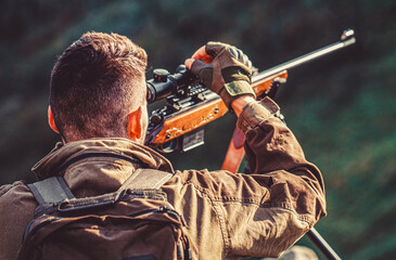 Hunting period. Male with a gun. Close up. Hunter with hunting gun and hunting form to hunt. Hunter...