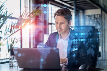 Handsome businessman in suit at workplace working with laptop to hire new employees for...