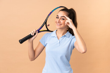 Young woman tennis player over isolated wall © luismolinero