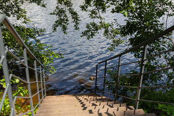 View of stairs going down towards the edge of the water