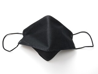A black mask on a white background gives a thoughtfulness to the prevention of infectious diseases of the respiratory system.  Gives a feeling of security and peace of mind