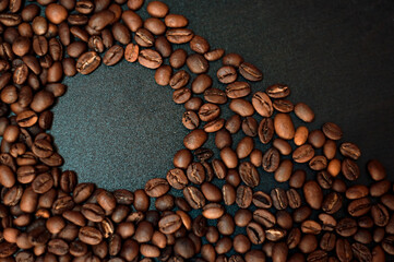 roasted coffee beans on a black wooden table. High quality photo