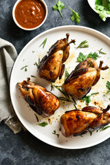 Roasted quails on white plate