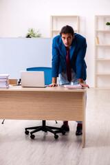 Young male employee in oversleeping concept in front of whiteboa