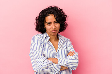 Young curly latin woman isolated on pink background who is bored, fatigued and need a relax day.