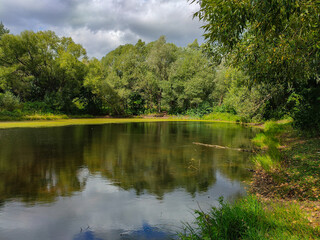 Landscape view of a green park with pond