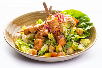 Chicken skewers on wooden skewers and vegetable salad 