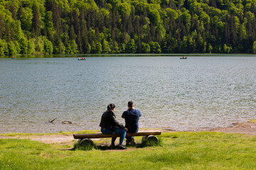 landscape with tourists on the shore of Lake Sfanta Ana - Romania