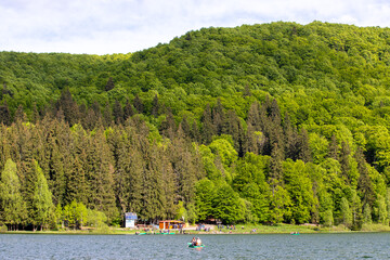 tourists with boats on Saint Ana Lake in Romania