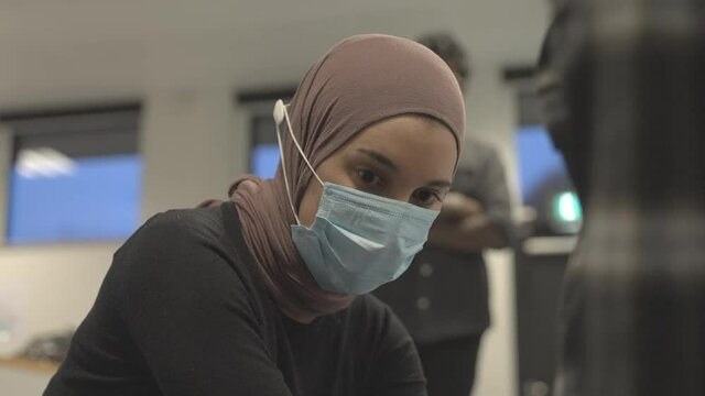 Female Wearing A Hijab Observes As A Person Does Chest Compression