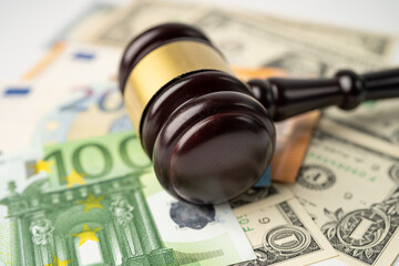 Gavel for judge lawyer and US dollar with EURO banknotes, finance concept.