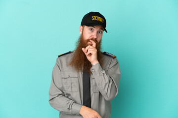 Redhead security man isolated on white background surprised and shocked while looking right