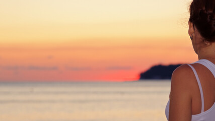 girl at sunset by the sea vacation tourism season