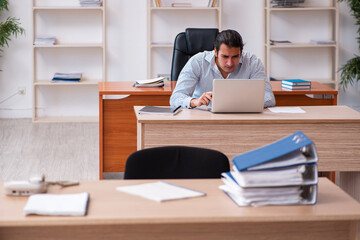 Young male employee sitting in the office