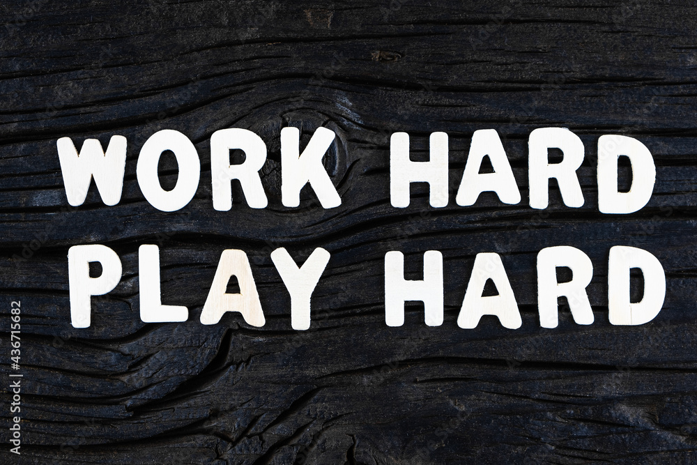 Wall mural work hard play hard words on dark wooden background. business, motivational and inspirational concep