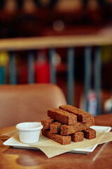 brown crispy sticks of  fried garlic bread on a white plate for snack