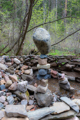Stacked rocks balancing at a forest creek in Stolby Nature Reserve in Krasnoyarsk, Russia