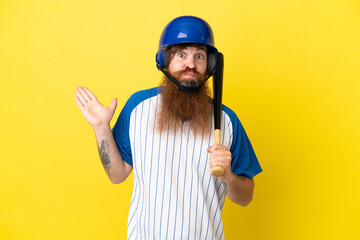 Redhead baseball player man with helmet and bat isolated on yellow background having doubts while raising hands