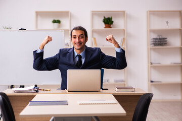 Young male employer in front of white board