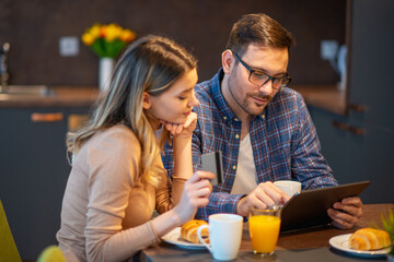 Excited young couple shopping online