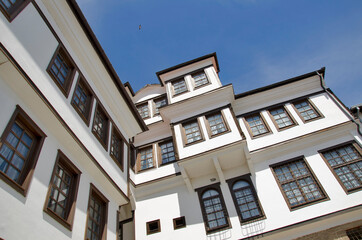 Abandoned white old house vintage style with wooden windows on clear blue sky