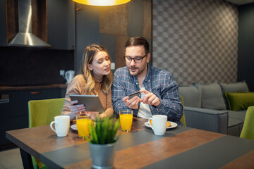 Excited young couple shopping online