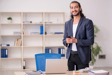 Young male employee working in the office