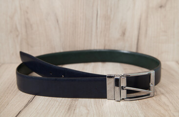Leather belt on an isolated wooden background. Men belt.