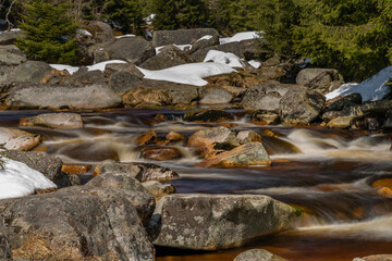 Color Jizerka river near confluence with Jizera creek in spring winter sunny day