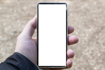 A smartphone in the hands of a person. The blank for the inscription on the smartphone.