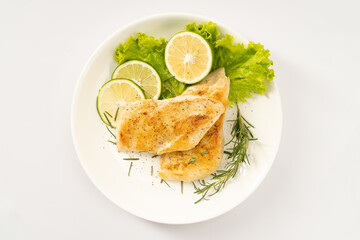 Pan-fried chicken breast on a solid background