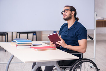 Young male handicapped student in the classroom