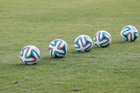 Varna, BULGARIA - MAY 30, 2015: 5 official FIFA 2014 World Cup balsl (Brazuca) on the grass. Adidas, a major German company