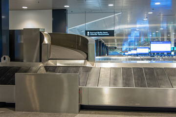 Empty conveyor belt for luggage at the airport. Terminal of airport without people.