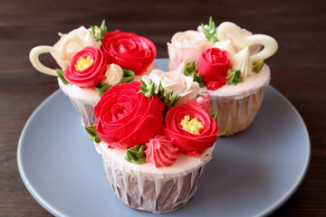 Plate of stunning flower bouquet shaped frosting cupcakes on dark brown background
