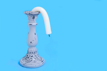 Candle Holder with a Drooping Candle on a Blue Background Concept Impotence Impotence and Old Age in Sex - obrazy, fototapety, plakaty