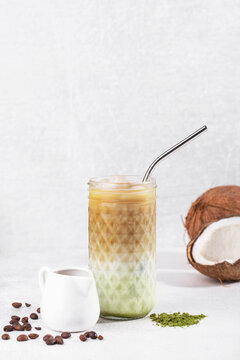 iced matcha coffee with coconut milk and ice on a white background, vertical