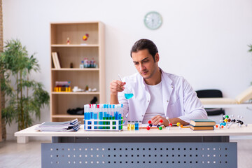 Young male chemist working in the lab