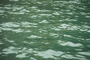 Detail of a sunlight reflecting in glittering sea. sparkling in water - background. sea water with...
