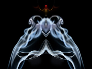 Swirls of Colorful smoke against a black background that resemble a Rorschach test or an alien,...