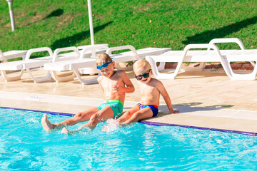 Happy little kids having fun at the pool