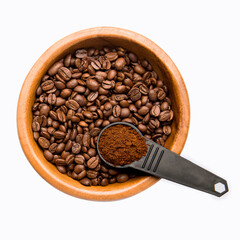 Fototapeta premium Plate with coffee beans and a spoon of ground coffee isolated on a white background.