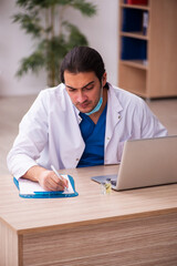 Young male doctor working in the clinic